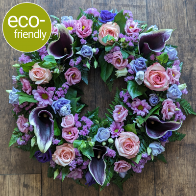Eco-Funeral Wreath, Pink & Purple: A Beautiful and Meaningful tribute - This beautiful and eco-friendly funeral wreath is a perfect way to pay your respects to a loved one. The pink and purple flowers represent love, grace, and appreciation.